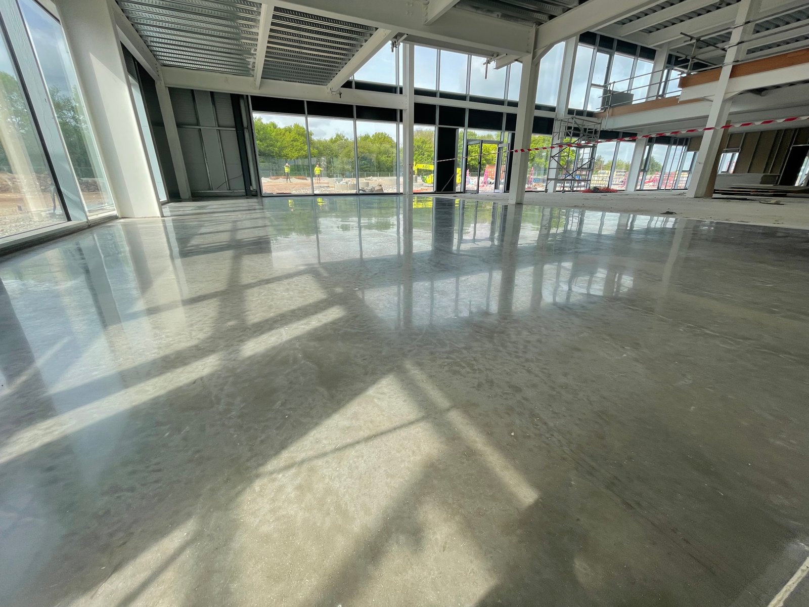 Commercial polished concrete retail showroom — natural grey