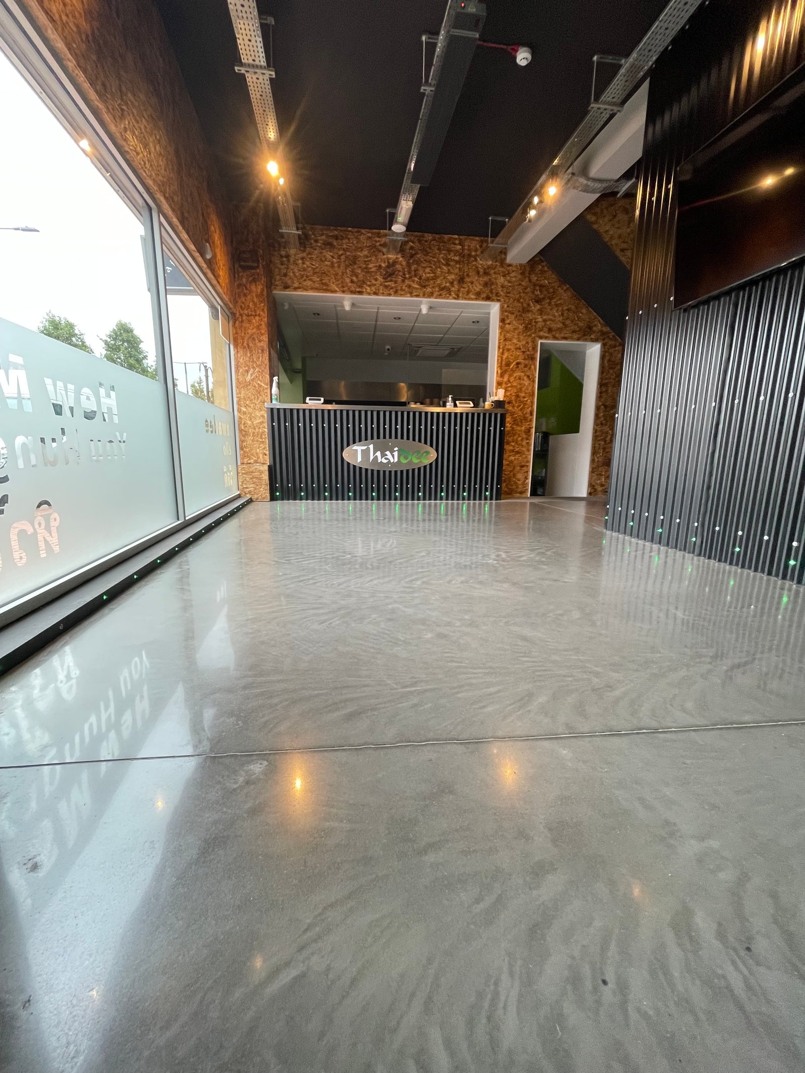 Commercial polished concrete — satin finish restaurant corridor
