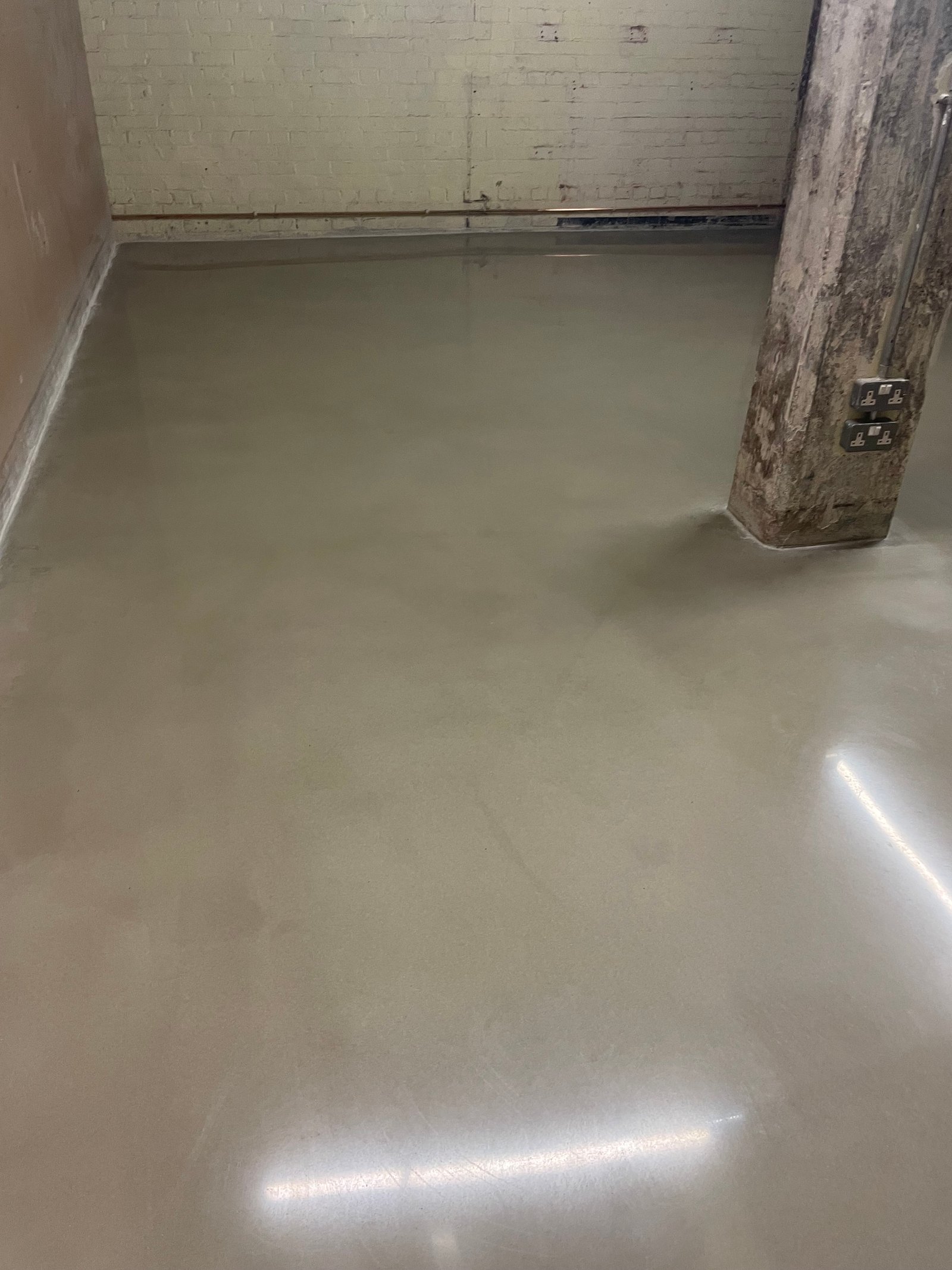 Polished concrete overlay in open-plan living and dining room