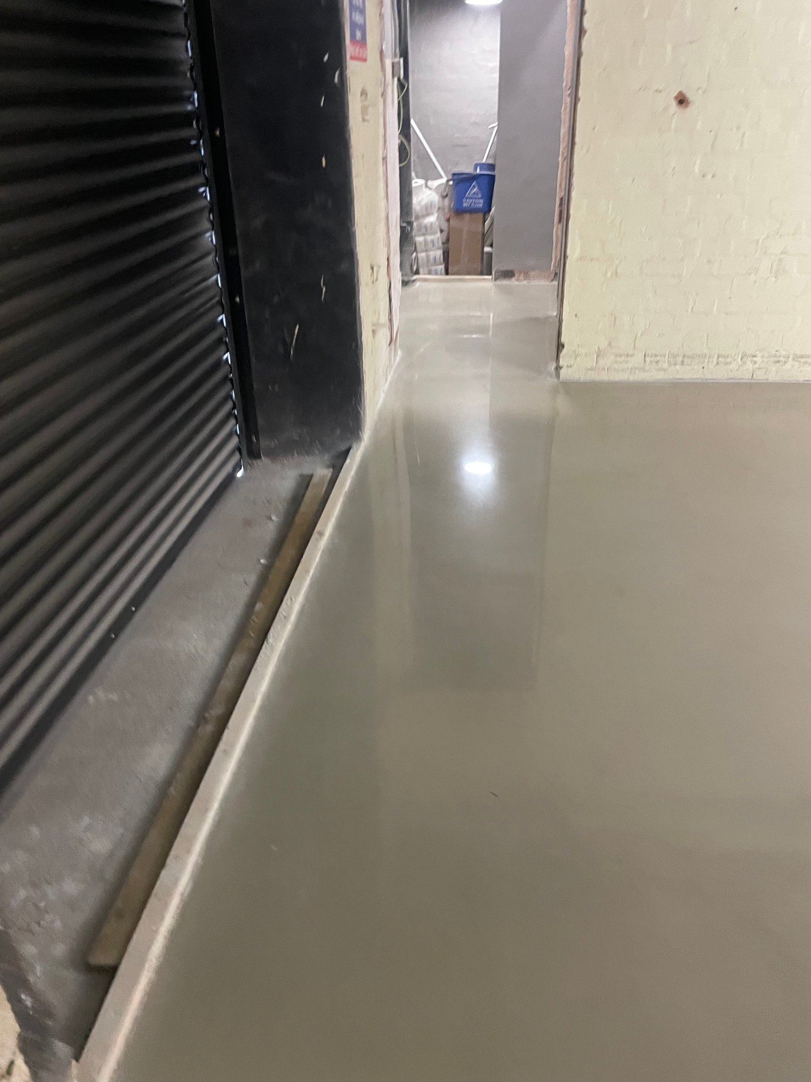 Microcement overlay corner and cove detail against brick wall